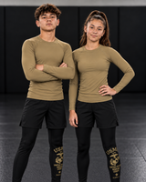 Roll Gear Youth Marines Gold Compression Spats, teen boy and girl wearing the spats on the mat, front view.