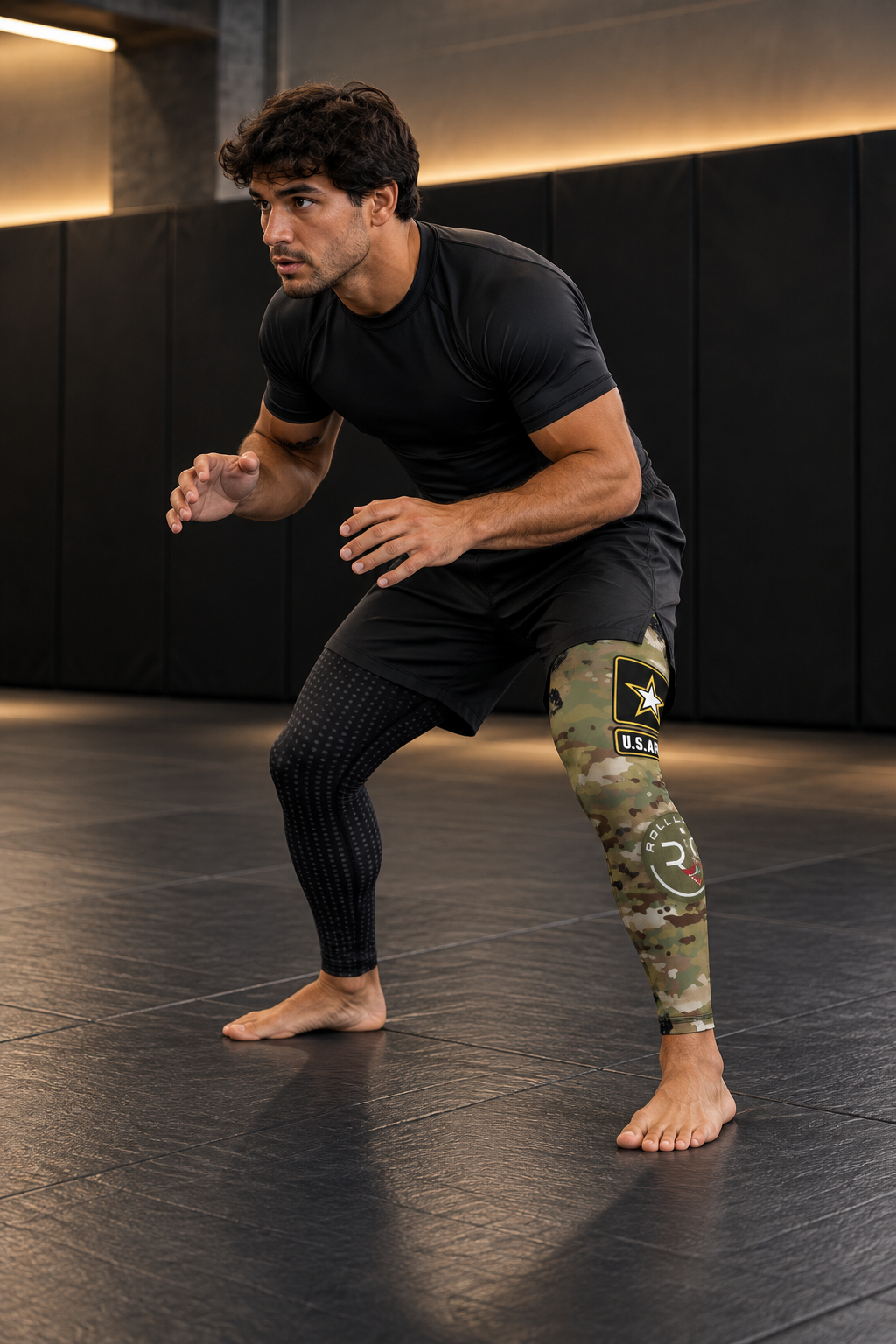 Roll Gear Men's Army Compression Spats – Black Camo, man in a grappling stance.