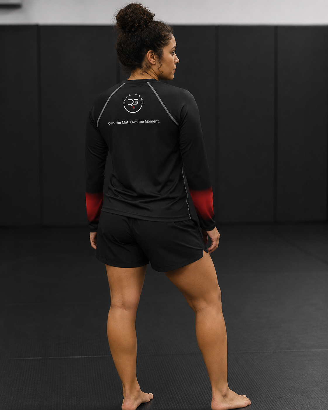 Roll Gear Black Fade Long Sleeve Rash Guard – Black/Red – Women’s, back view showing the Roll Gear emblem.