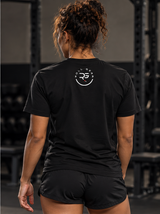 Roll Gear Women's Earned Not Given Motivational T-Shirt, back view, worn by the squat rack.