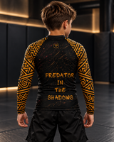 Roll Gear Jaguar Youth BJJ Rash Guard, back view on a boy, Predator in the Shadows text.