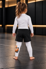 Roll Gear Tap Hype Spats – Orange & White – Kids, back view on a young girl.