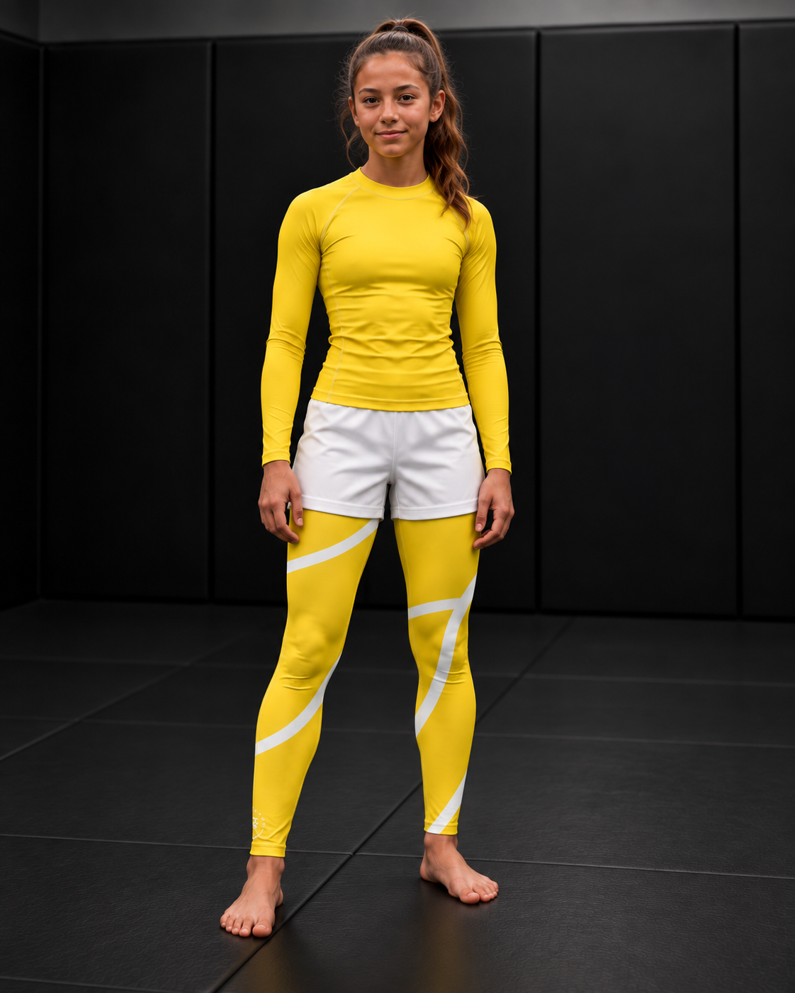 Roll Gear Yellow Swirl Spats – Yellow/White – Youth, front view on a teen girl on the mat.