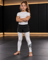 Roll Gear Tap Hype Spats – Blue & White – Boys Kids, front view on a child with arms crossed.
