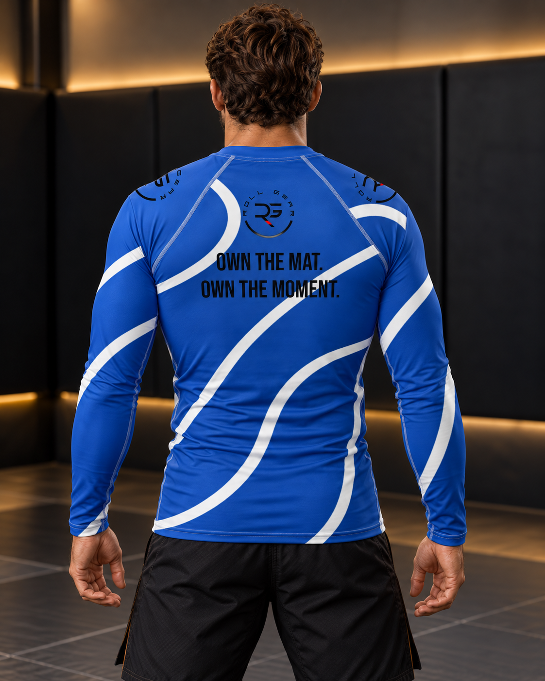 Roll Gear Blue Swirl Long Sleeve Rash Guard – Blue/White – Men’s, back view on a man, Own the Mat. Own the Moment. text.