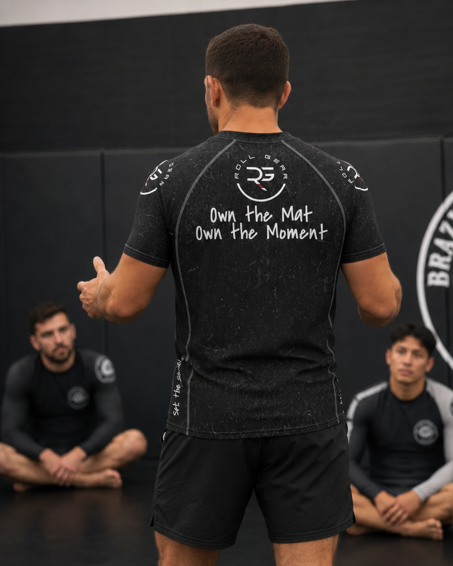 Roll Gear Tap Hype Short Sleeve Rash Guard – Black – Men’s, back view showing Own the Mat, Own the Moment.