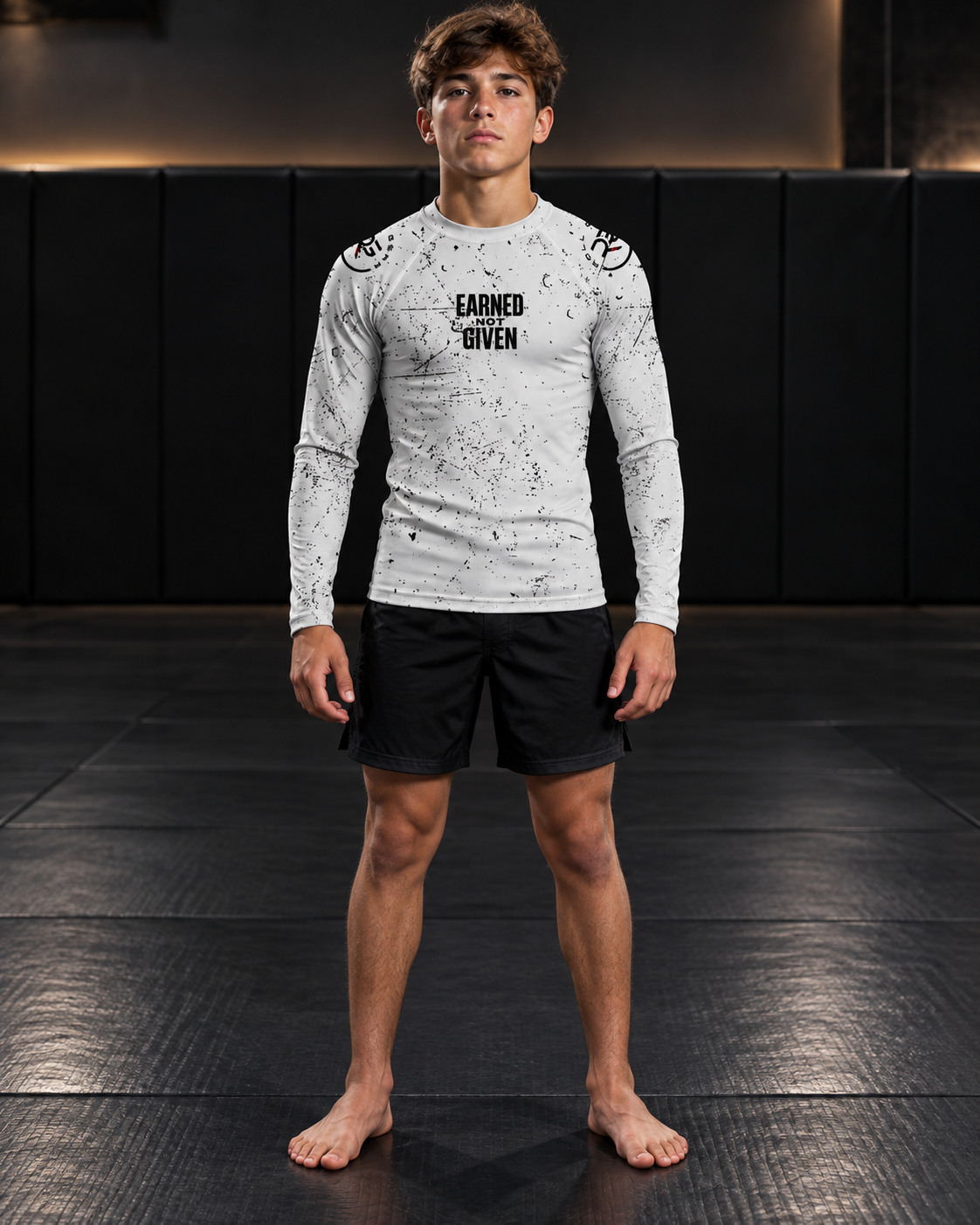 Roll Gear Kids Long Sleeve Rash Guard with White Lines, front view on a teen boy, Earned Not Given graphic.