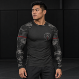 Roll Gear Men's Special Forces Edition Rash Guard, man standing in a gym, angled front view.