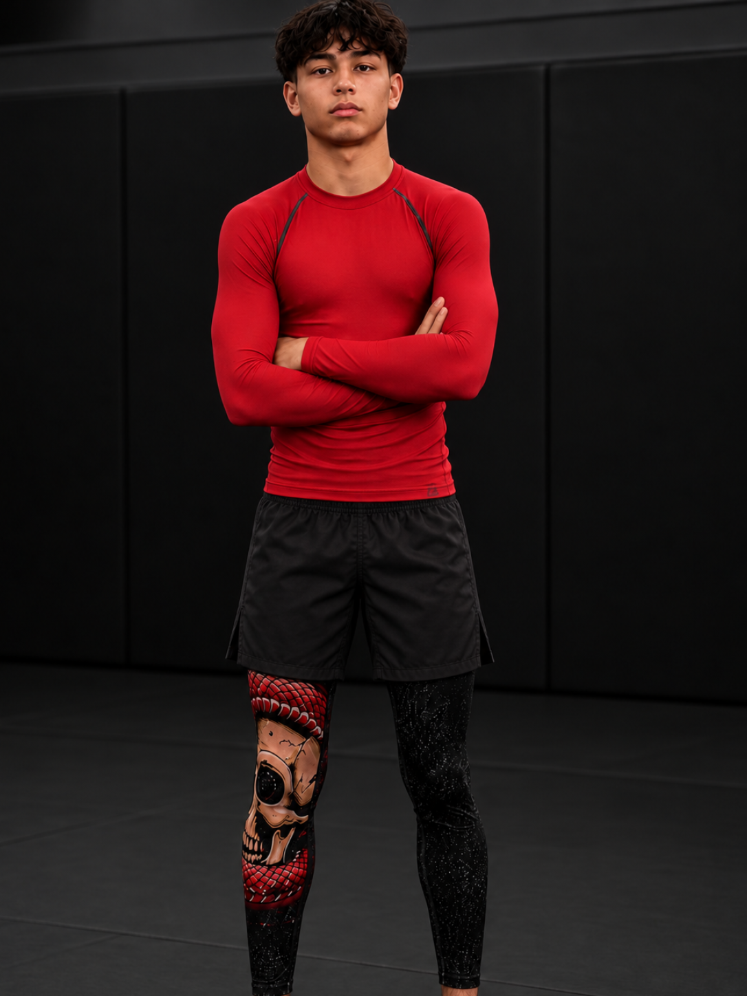 Roll Gear Cold Blooded Spats – Black Venom, worn with a red rash guard by a man on the mat.
