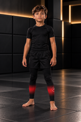 Roll Gear Black Fade Training Spats – Black/Grey – Kids, front view on a boy.