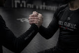 Two individuals arm wrestling with 'Roll Gear LLC' branding on their shirts.