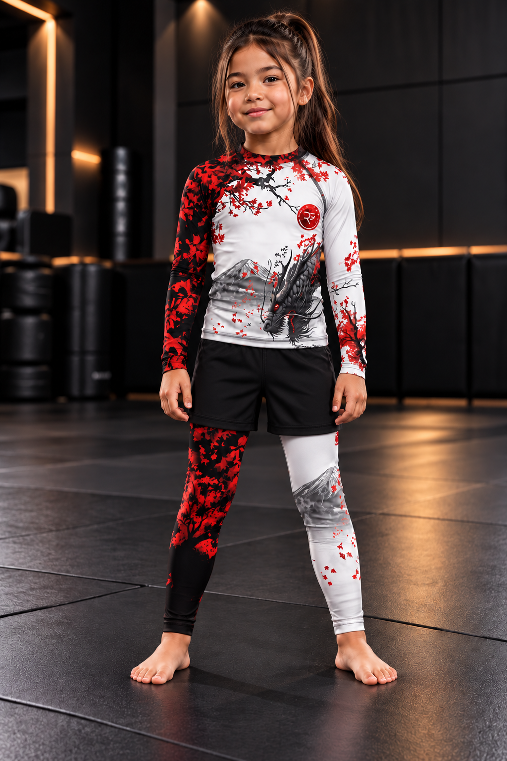 Roll Gear Shadow Dragon Warrior Kids Rash Guard and Spats – White & Crimson, girl standing on the mat, front view.