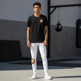Roll Gear Tap Hype Youth BJJ Spats – Orange & White, teen boy standing outdoors, front view.