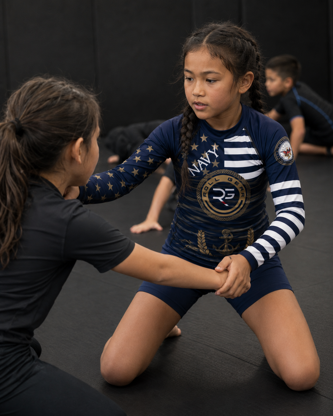 Two children in a martial arts class, one assisting the other on a mat.