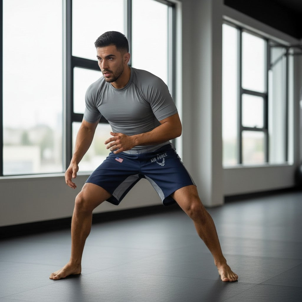 Roll Gear Air Force grappling shorts in navy blue with grey accents and Air Force logo. Features split-leg design.