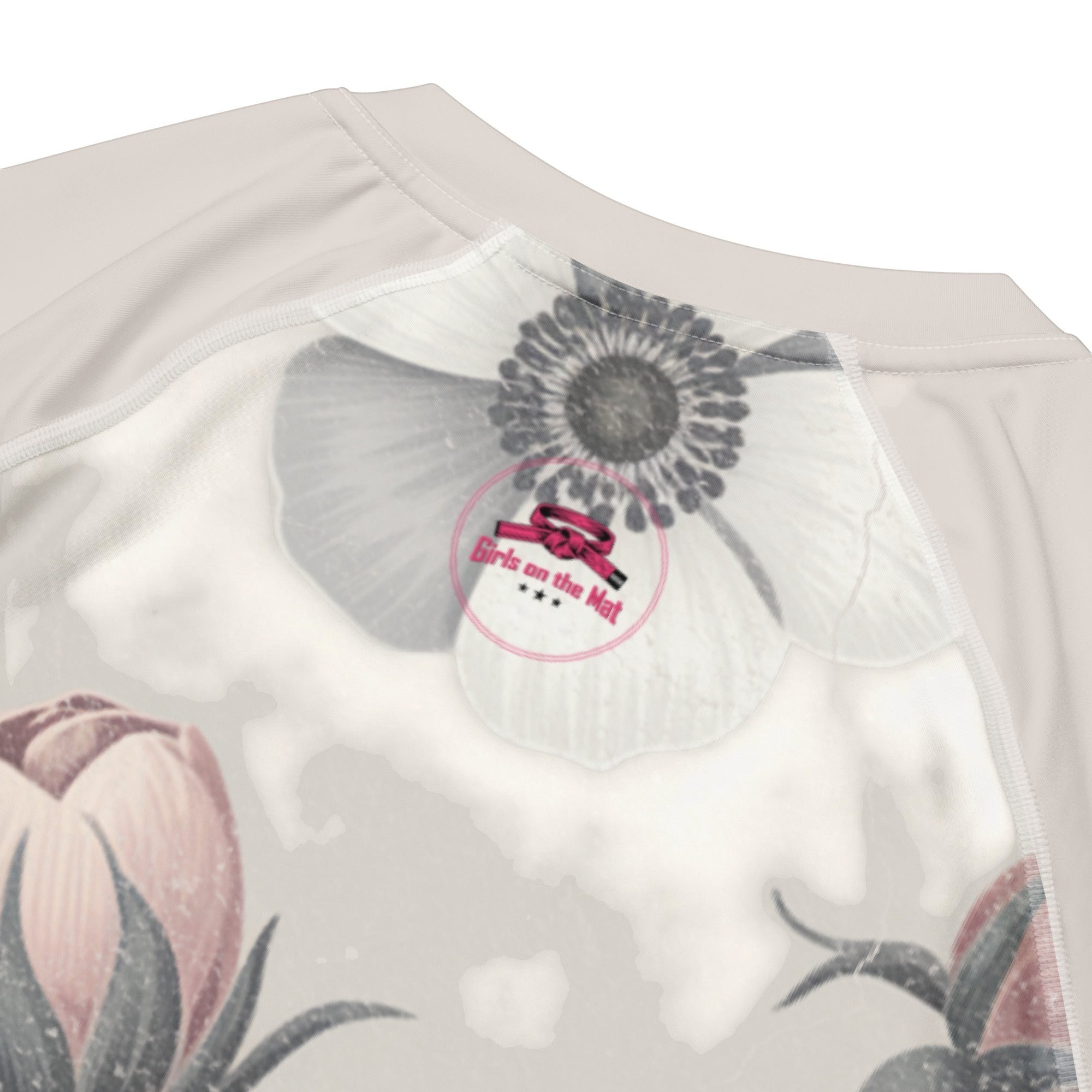 Roll Gear Always Blooming Women's Short Sleeve Rash Guard, close-up of the Girls on the Mat badge at the collar.