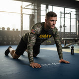 Roll Gear Men's Army Classic Long Sleeve Rash Guard, worn by a man in a crawl position on a gym floor.