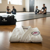 Roll Gear Girls on the Mat circular embroidered patch with pink design on black background, iron-on/sew-on/pin attachment.
