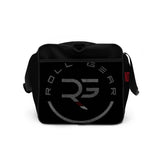 Black polyester duffel bag by Roll Gear LLC with "Earned Not Given" graphic and "RG" logo. Features padded handles and shoulder strap.