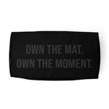 Roll Gear LLC black polyester duffel bag with "OWN THE MAT. OWN THE MOMENT." graphic. Ideal for training.