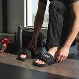 Roll Gear black men's slides with cushioned footbed and secure strap, ideal for recovery.