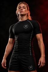 Roll Gear Solid Performance Rash Guard – Black – Adult Unisex, front view, worn by a female athlete.