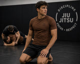 Roll Gear brown short sleeve BJJ rash guard with reinforced seams and four-way stretch fabric for unrestricted movement.