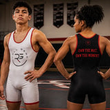 Two athletes modeling singlets in a wrestling gym. The male athlete on the left wears a white singlet with red trim and a circular 'Roll Gear' logo.