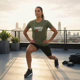 Roll Gear olive green cotton t-shirt with white and red "Earned Not Given" graphic, worn by a man doing lunges.