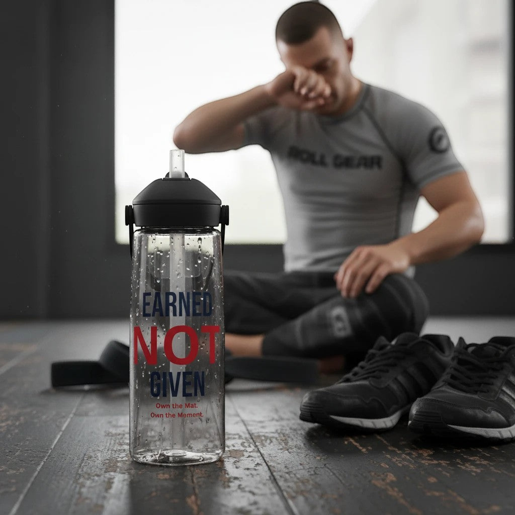 Roll Gear Earned Not Given Water Bottle – 25 oz, bottle beside a man tying his shoes.