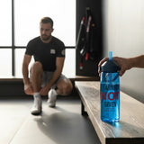 Roll Gear blue 25 oz water bottle with "Earned Not Given" text and straw lid, held by a hand. A man is tying his shoes in the background.