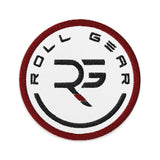 Roll Gear circular embroidered patch with black RG logo on white, red border. 3" diameter, cotton-polyester twill.