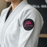 Roll Gear black circular patch with pink embroidered "Girls on the Mat" text and graphic.