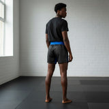 Roll Gear Police Tribute Edition black grappling shorts with blue trim and waistband, featuring a split-leg design for mobility.