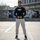 Roll Gear Heavyweight grey cotton-poly fleece joggers with a relaxed fit and subtle logo detail on the left ankle.