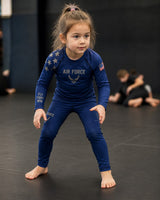 Roll Gear Kids Air Force blue long sleeve rash guard with silver graphics and US flag detail. Designed for active play and sports.