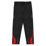 Roll Gear black compression spats for kids with red flame graphics and firefighter emblems. Four-way stretch polyester-spandex blend.
