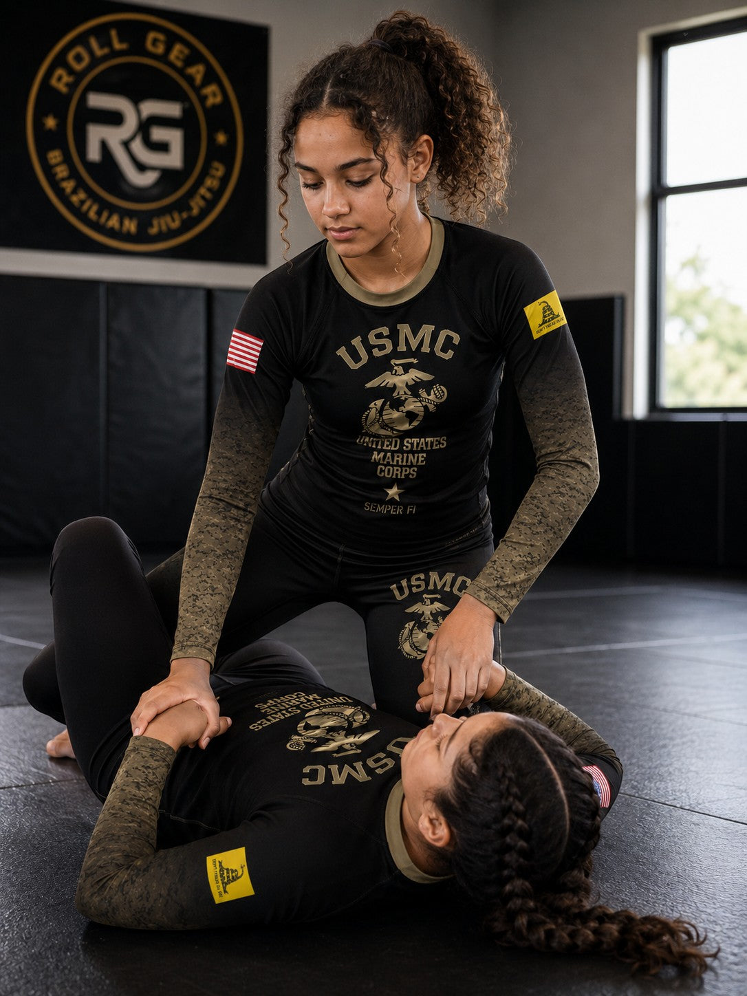 Roll Gear Kids Marines “Gold” Military Rash Guard – Black & Faded Gold, worn by two young athletes drilling on the mat.