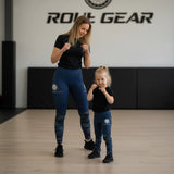 Roll Gear Kids Navy Compression Spats in deep navy blue with ocean camo fade on lower legs. Polyester-spandex blend.