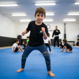 Roll Gear Kids Navy Compression Spats in deep navy blue with ocean camo fade on lower legs. Made of polyester and spandex.