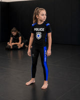Roll Gear kids black compression spats with blue thin line panels and police graphics. Made of polyester and spandex.