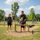Roll Gear Kids SWAT Edition Long Sleeve Rash Guard, worn by kids training outdoors with a coach.