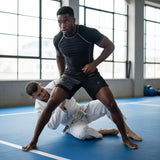 Roll Gear SWAT Grappling Shorts, man standing over a partner on the mat.