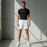 Roll Gear Mesh Shorts – All White – Unisex, worn by a man standing in a gym.