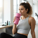 Roll Gear pink 20oz stainless steel tumbler with 'Girls on the Mat' BJJ design, held by a woman in athletic wear.