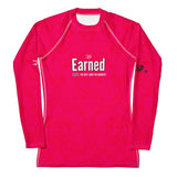 Roll Gear women's long sleeve rash guard in bright pink with a subtle pattern and "Earned" graphic. Designed for BJJ and grappling.