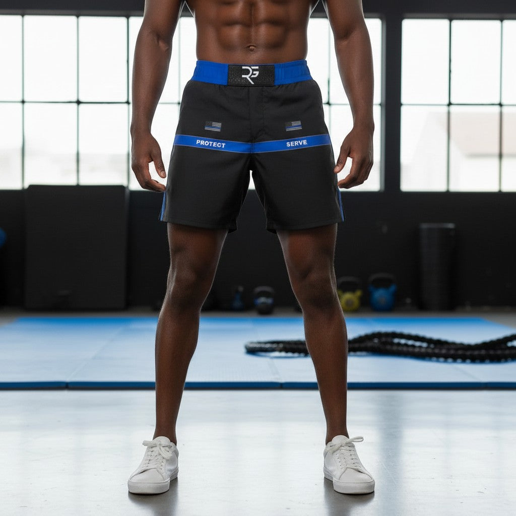 Roll Gear Police Tribute Edition grappling shorts in black with blue trim and "Protect / Serve" text. Lightweight, 4-way stretch fabric.