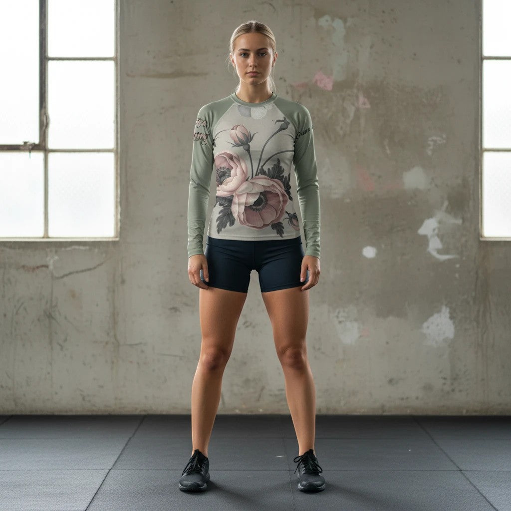 Roll Gear Always Blooming Rash Guard – Sage Green Athlete Edition – Women’s Long Sleeve, worn by a woman standing in a gym.