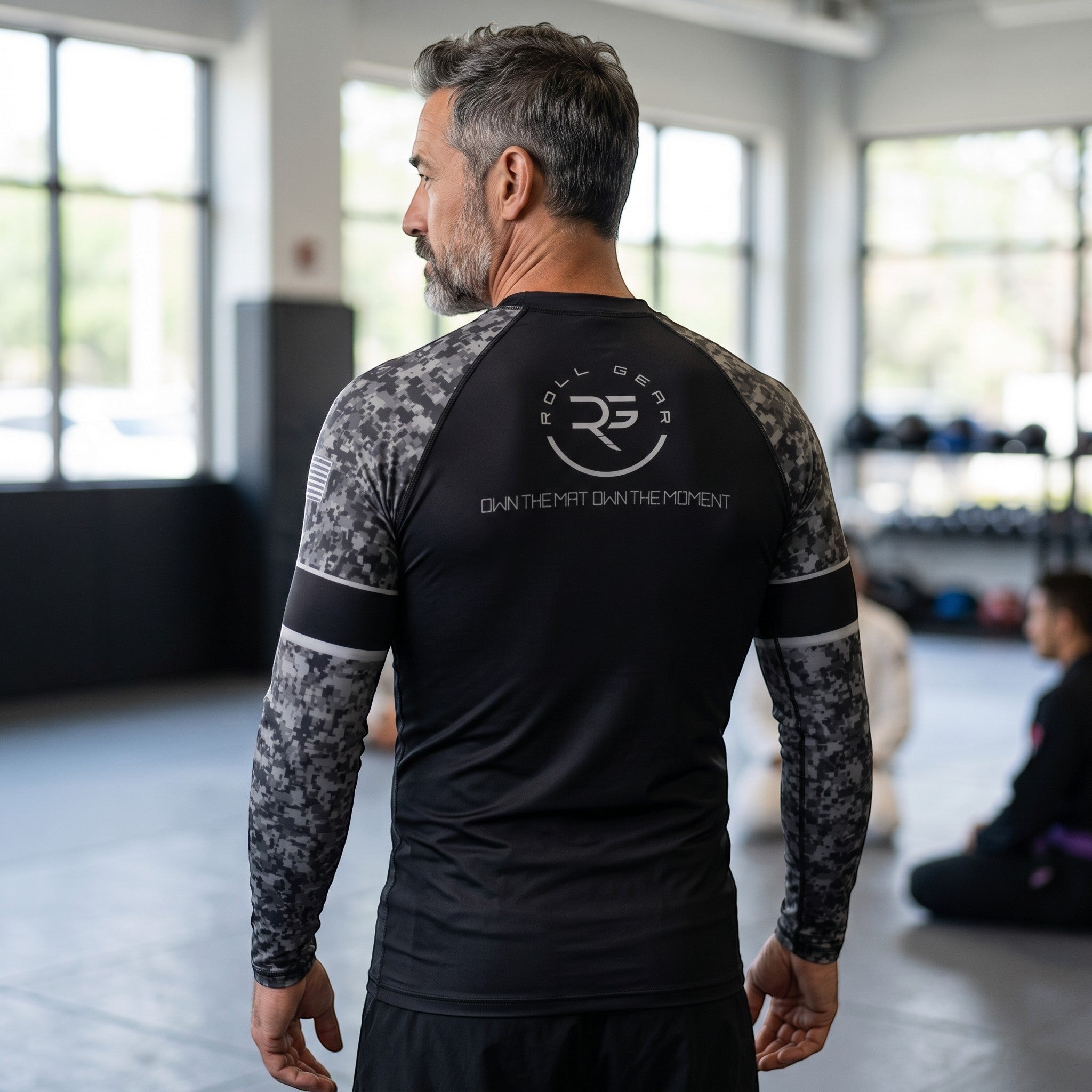 Roll Gear Men's SWAT Edition long sleeve rash guard in black with urban camo sleeves and tactical graphics.