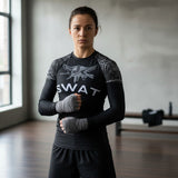 Roll Gear Women's SWAT Edition Long Sleeve Rash Guard, front view, worn with hand wraps in the gym.